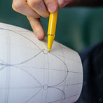 Rhian Malin decorating a mandala bottle in her workshop 2019